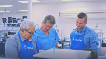 PRO-Craft dental lab team looking at a dental product